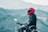 a man riding a motorcycle with a mountain in the background