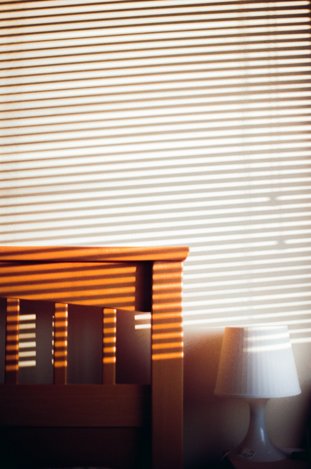 a small wooden table next to a window