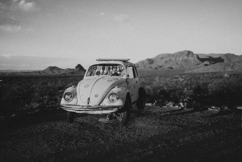 a car parked on the side of a dirt field