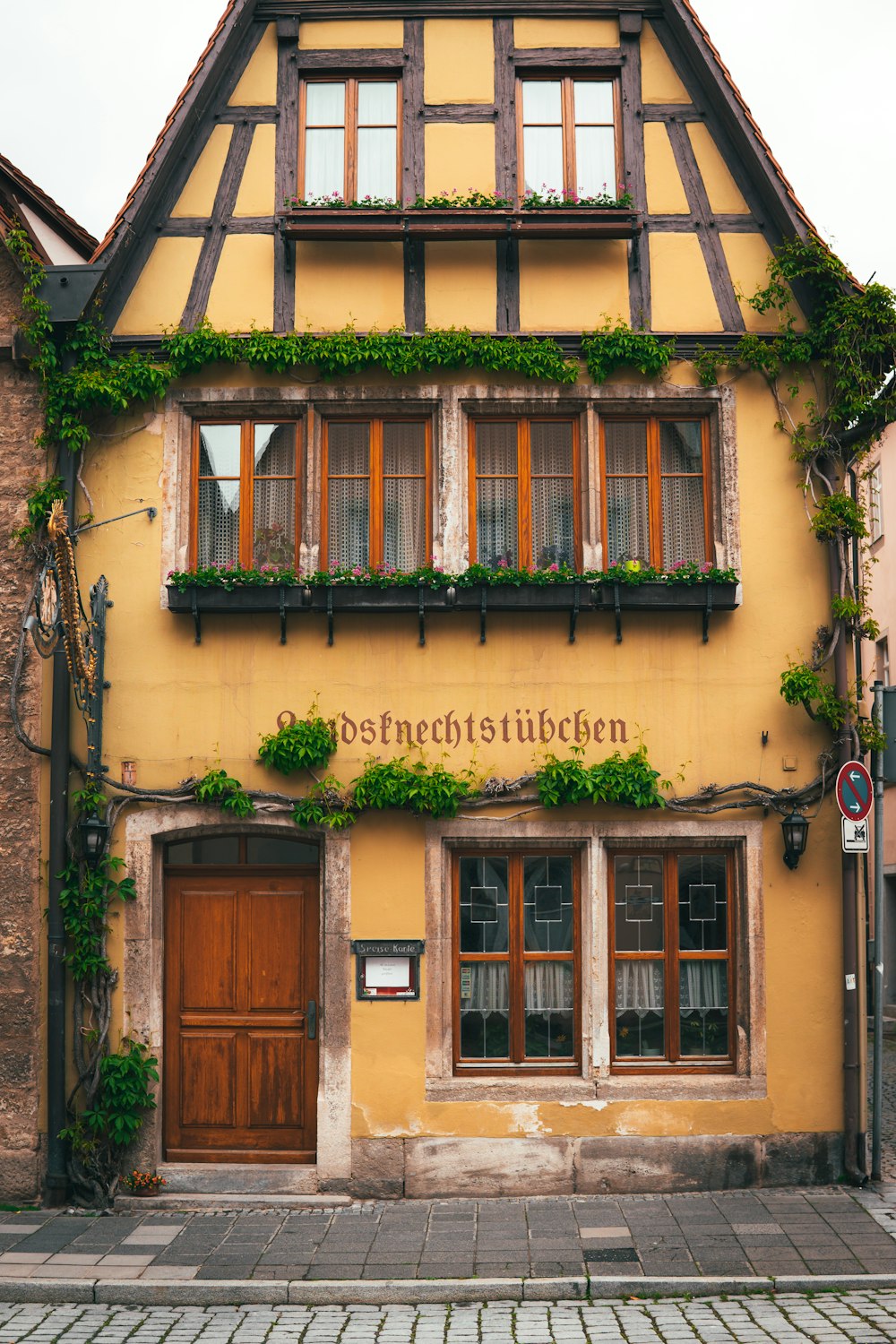 a building with a bunch of plants growing on the side of it