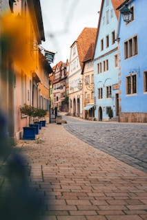 a cobblestone street lined with colorful buildings