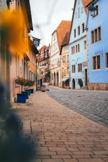 a cobblestone street lined with colorful buildings