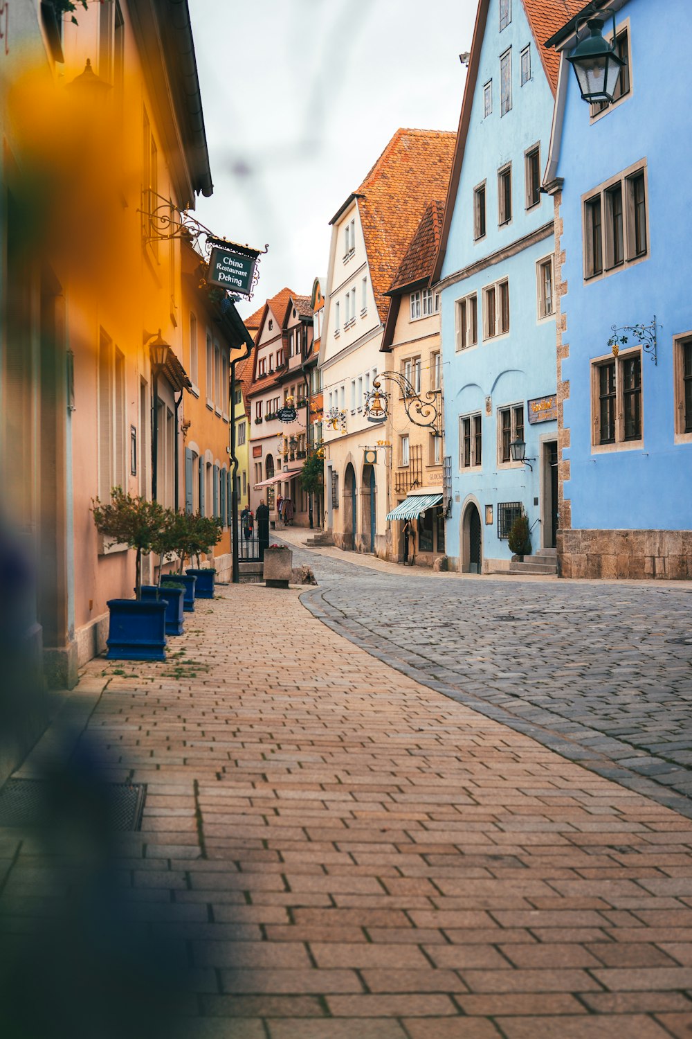 a cobblestone street lined with colorful buildings