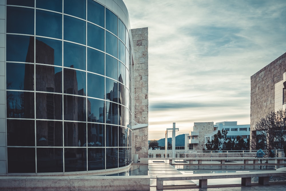 a building with a lot of windows and benches in front of it