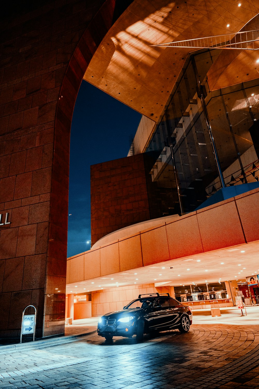 a car parked in front of a building at night