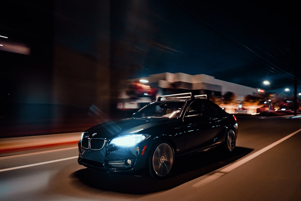 a car driving down a street at night