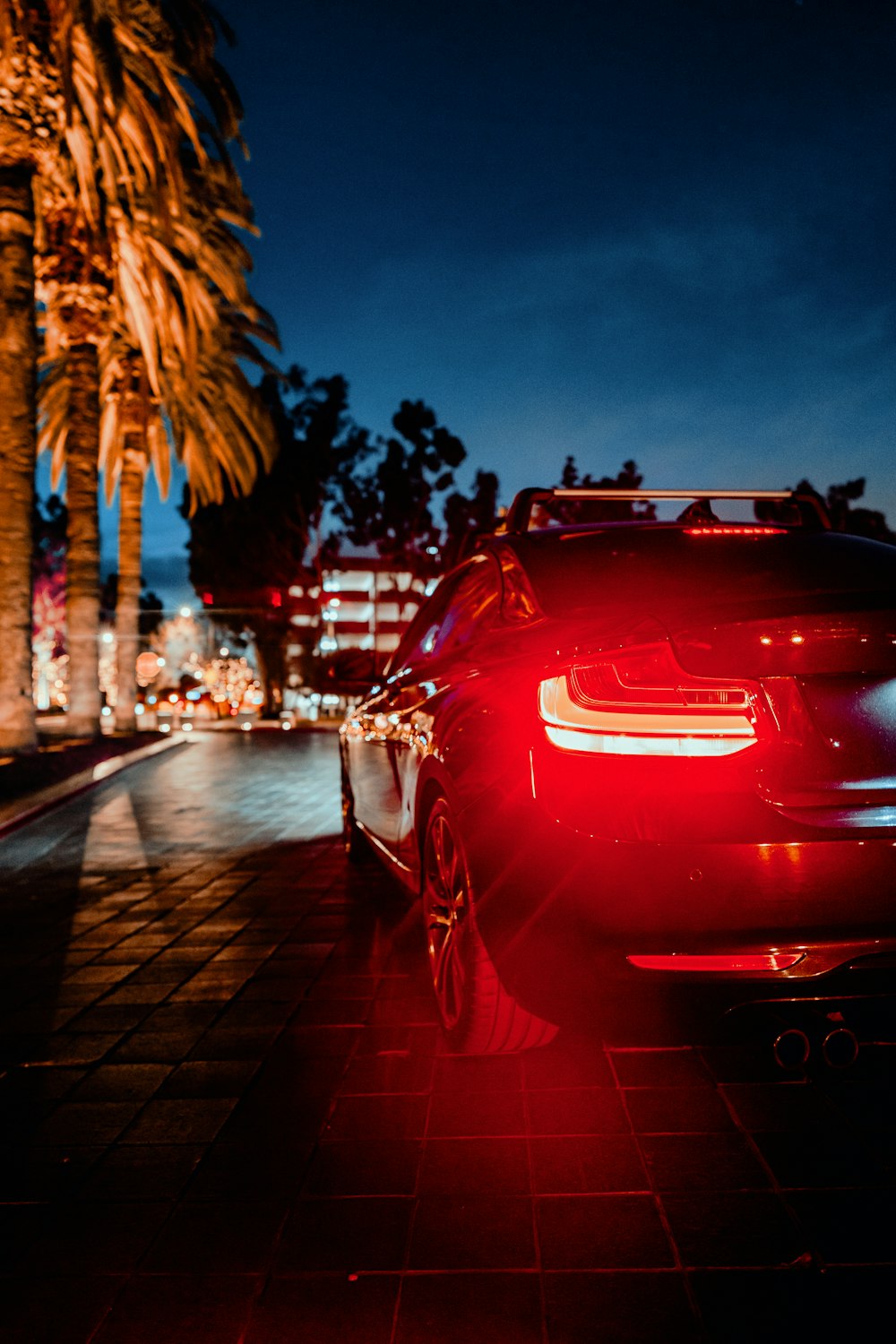 a car parked on the side of the road at night