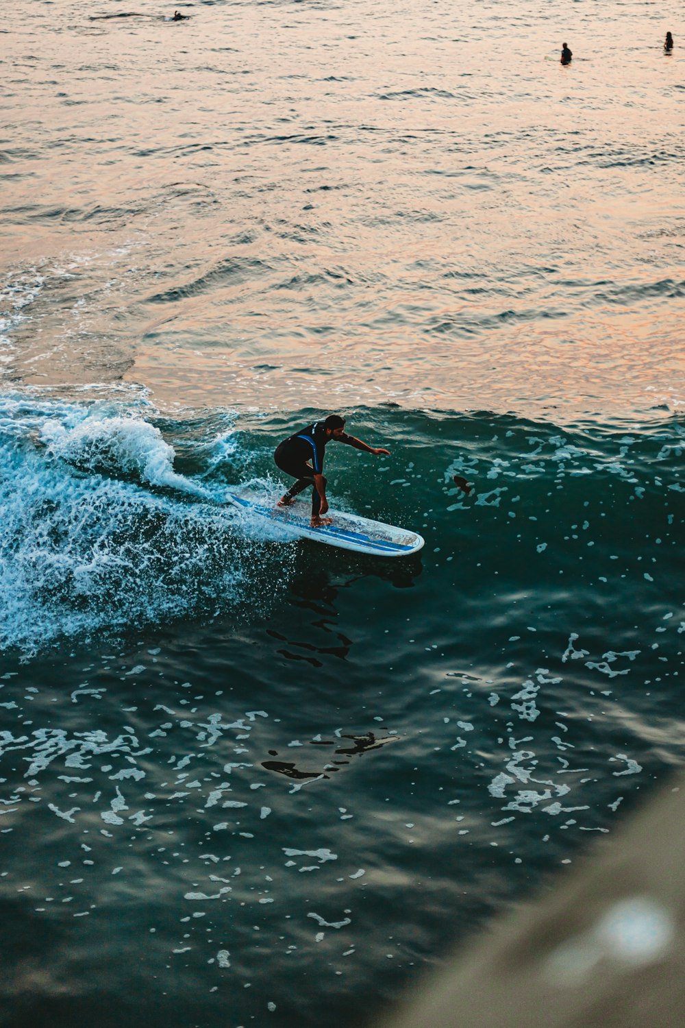 man surfing on sea waves during daytime