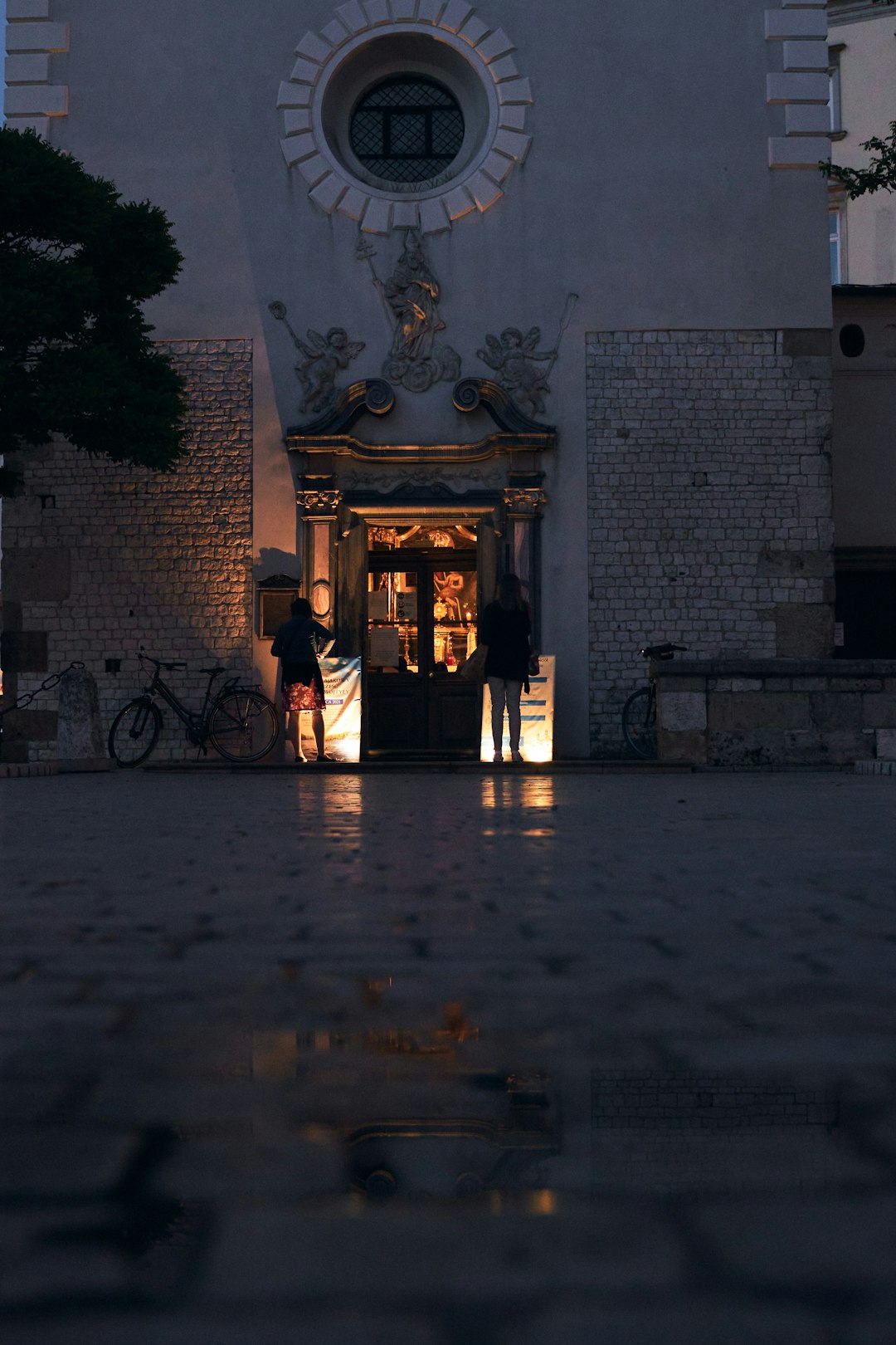 man in black jacket standing in front of brown concrete building