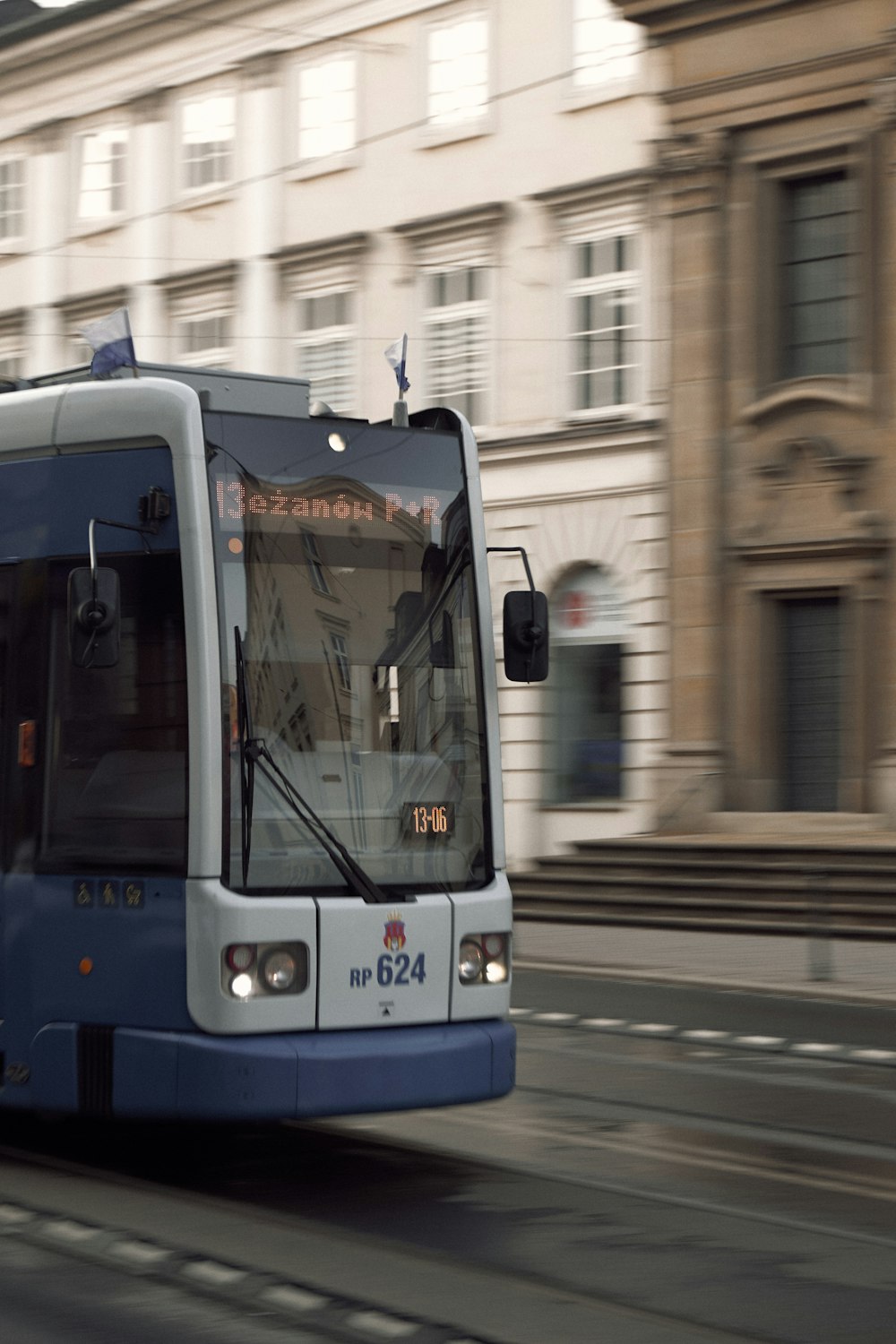 white and blue train on the city during daytime