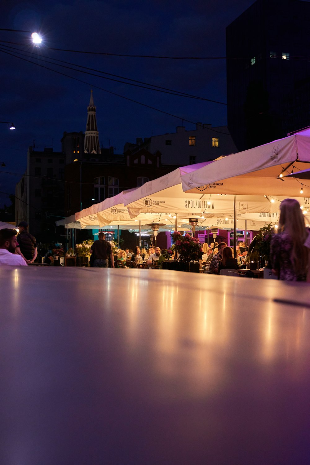 people sitting on chair under white canopy tent during night time