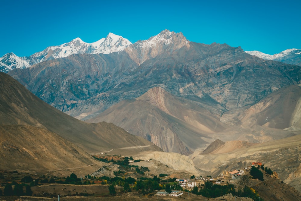 a mountain range with a village in the foreground