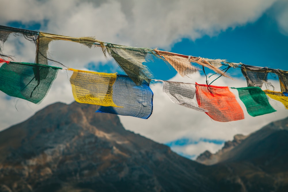 a bunch of colorful flags hanging from a line