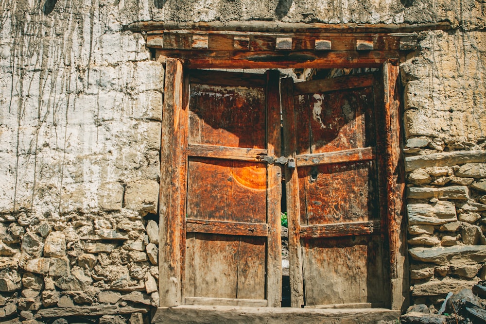 an old door is open on a stone building