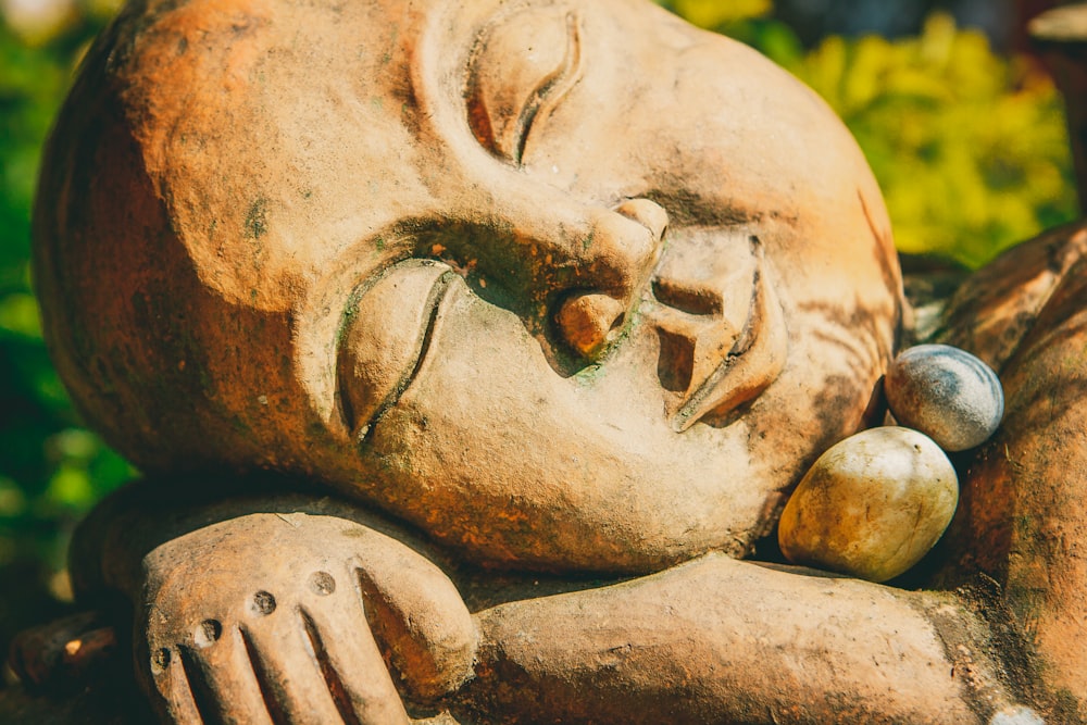 a close up of a statue of a sleeping person