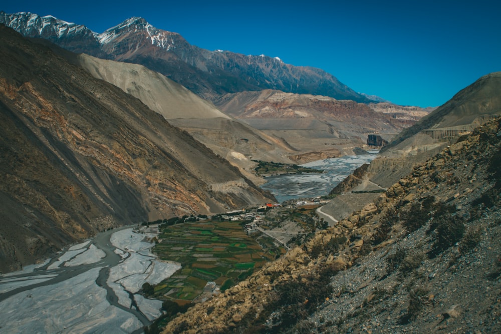 a view of a valley with mountains in the background