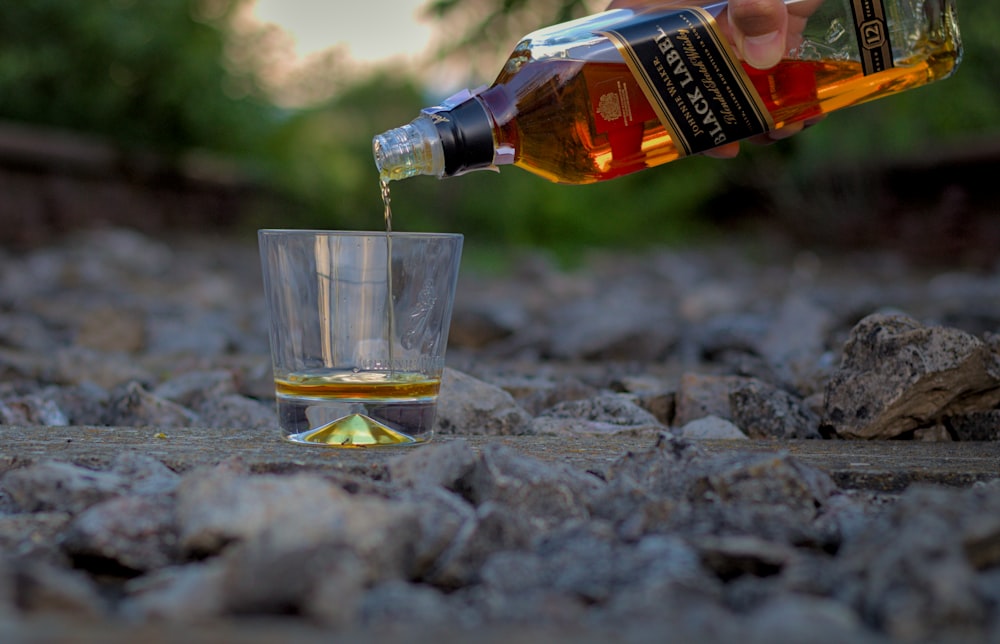 clear drinking glass with brown liquid