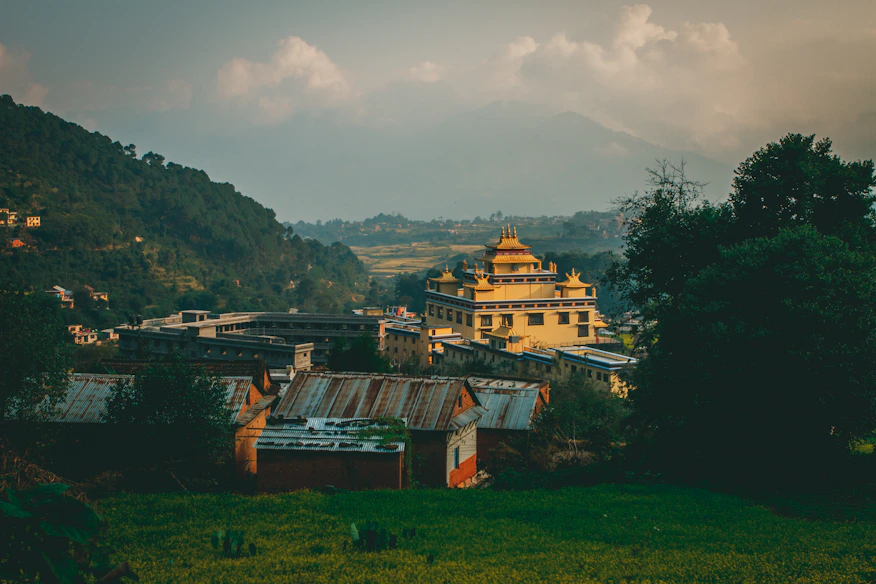 A serene Himalayan valley with ancient temples nestled among lush greenery under a golden sunset.