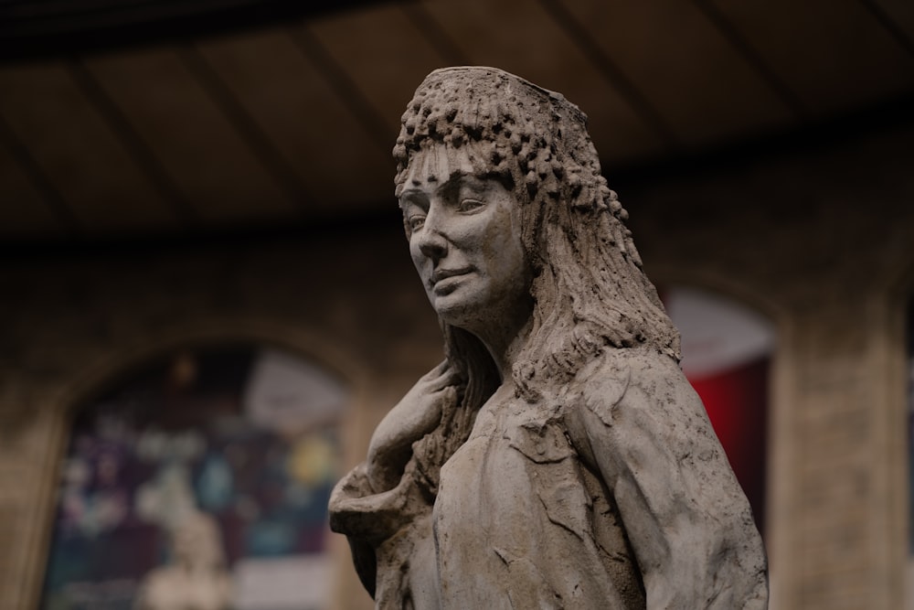 a statue of a woman with a scarf around her neck