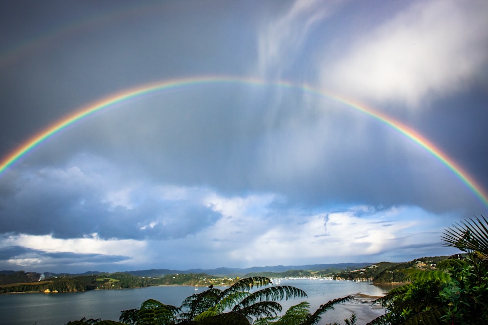 a double rainbow over a body of water