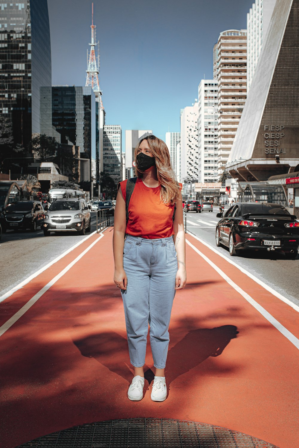 a woman standing in the middle of a city street