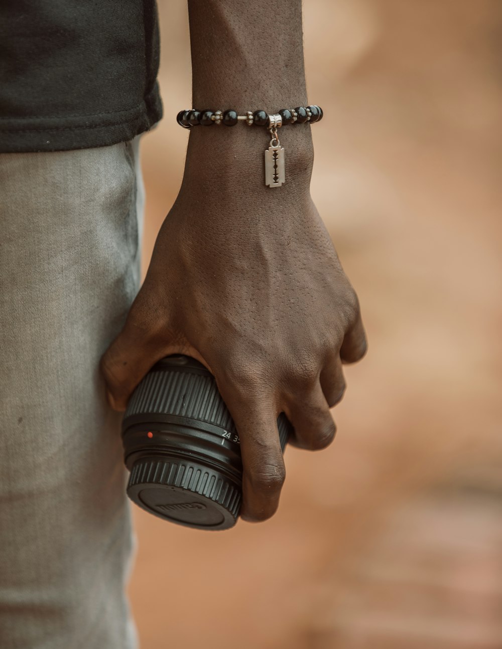 person holding black camera lens