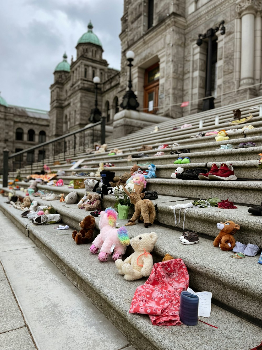 assorted plush toys on gray concrete road during daytime