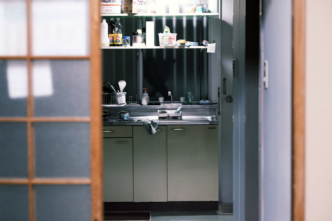 stainless steel sink beside brown wooden cabinet