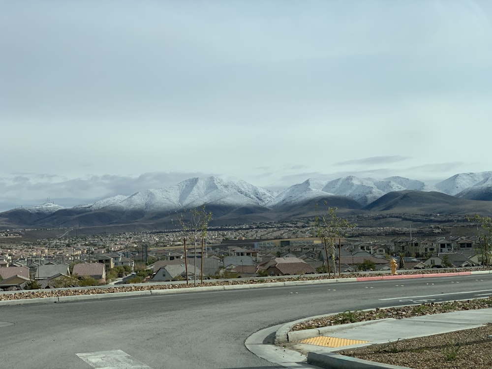gray concrete road near mountain during daytime