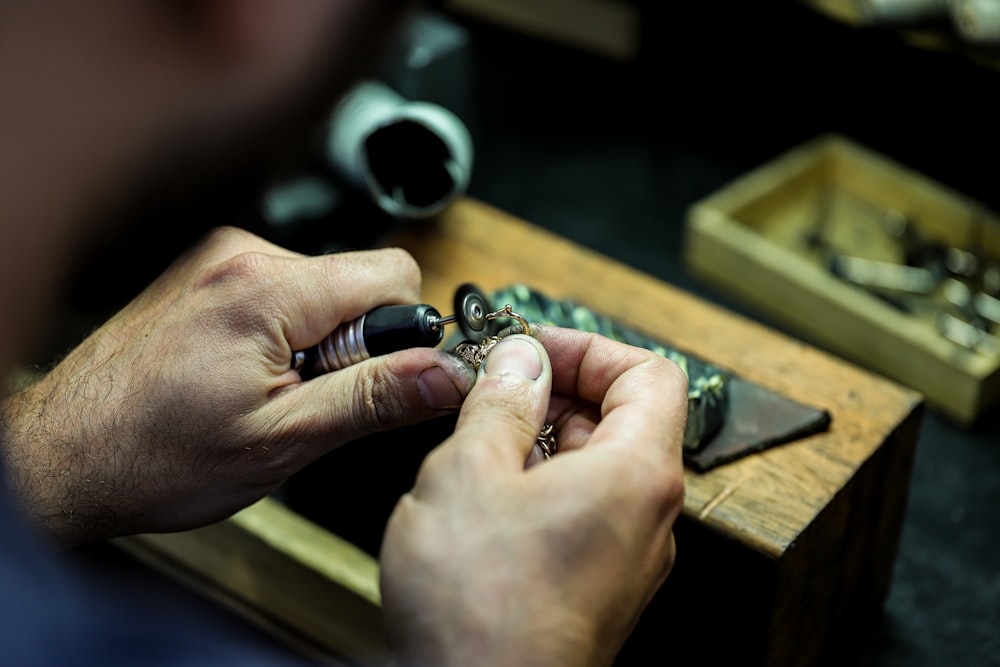 person wearing silver ring with black gemstone