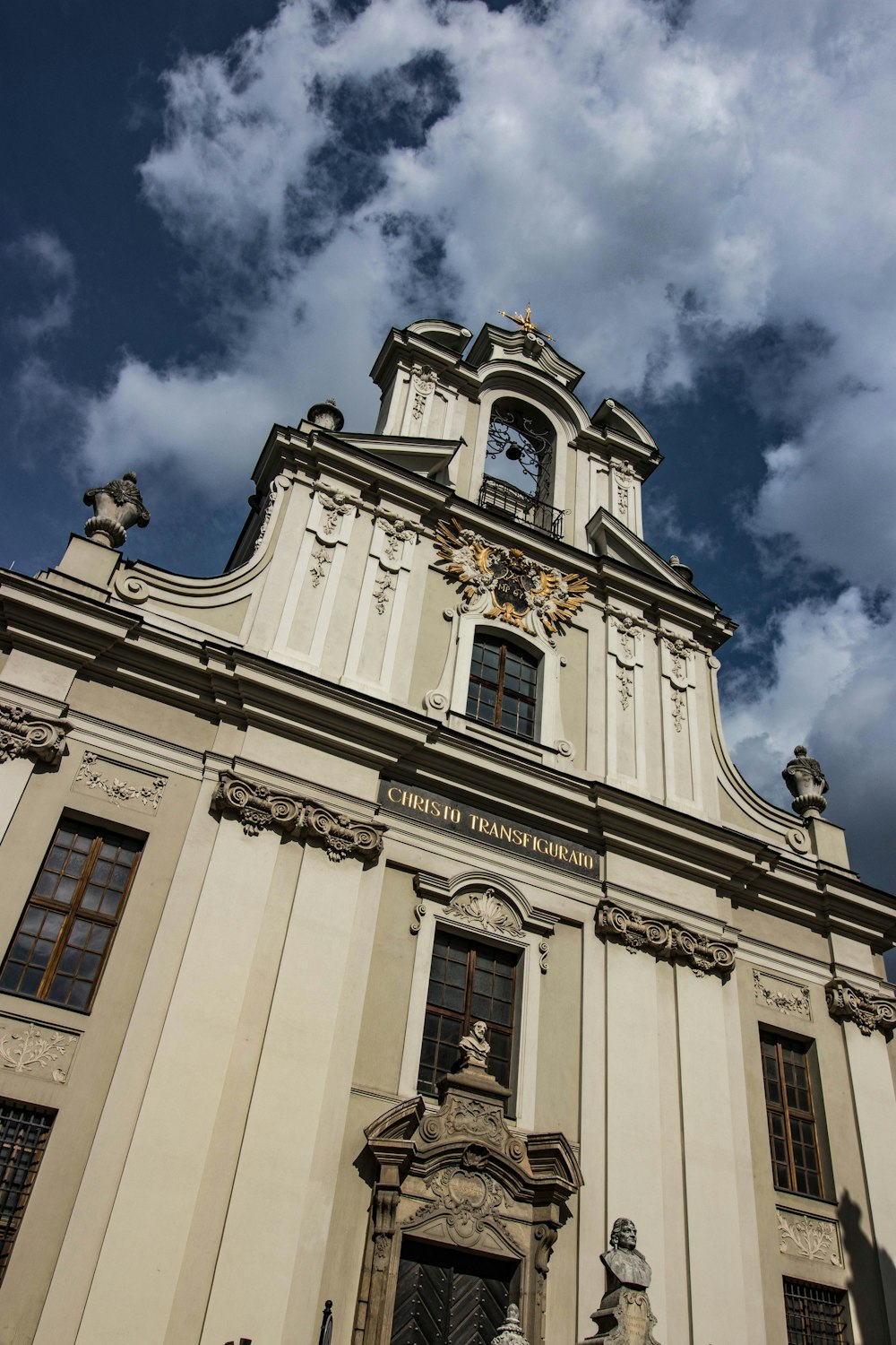 a tall white building with a clock on it's side