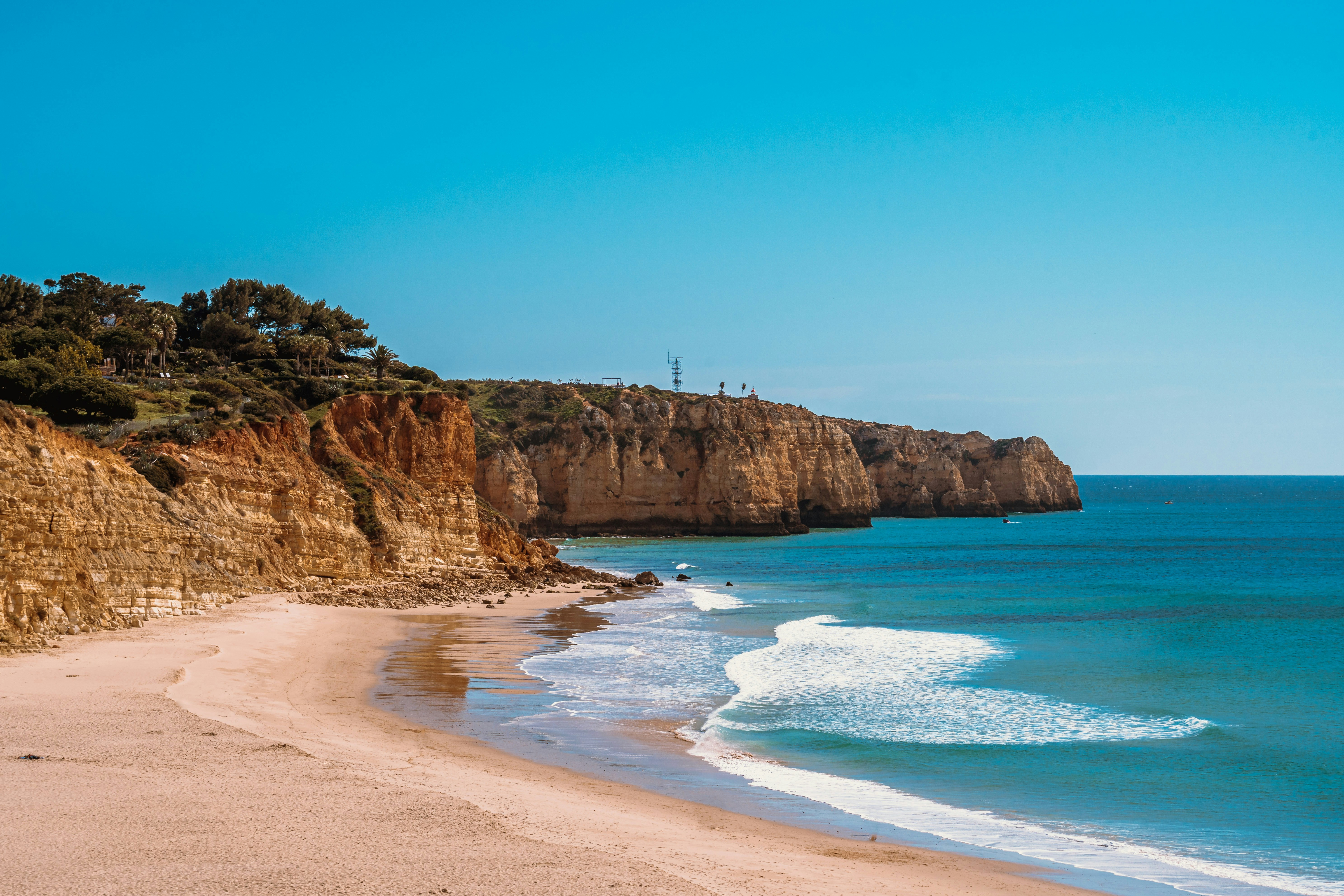 brown rock formation near body of water during daytime