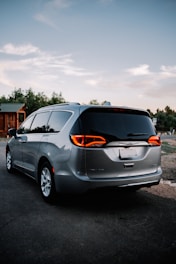 a silver minivan parked in a parking lot
