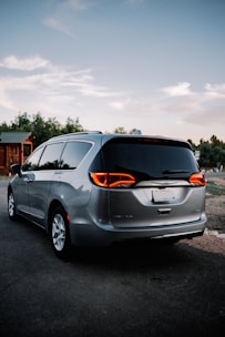 a silver minivan parked in a parking lot