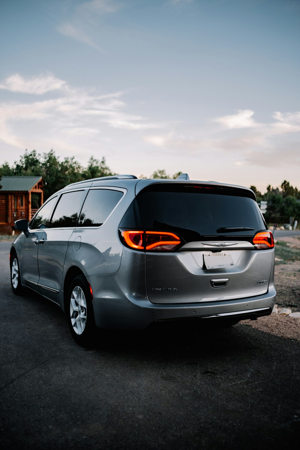 a silver minivan parked in a parking lot