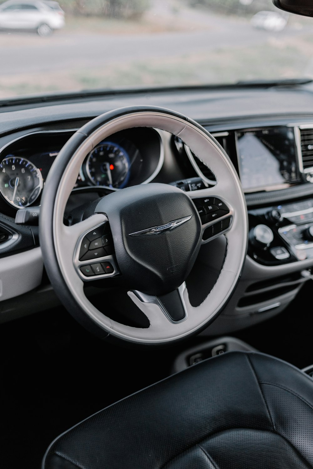 the interior of a car with a steering wheel and dashboard