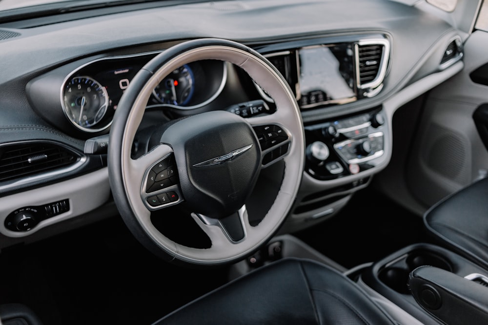 the interior of a car with a steering wheel and dashboard