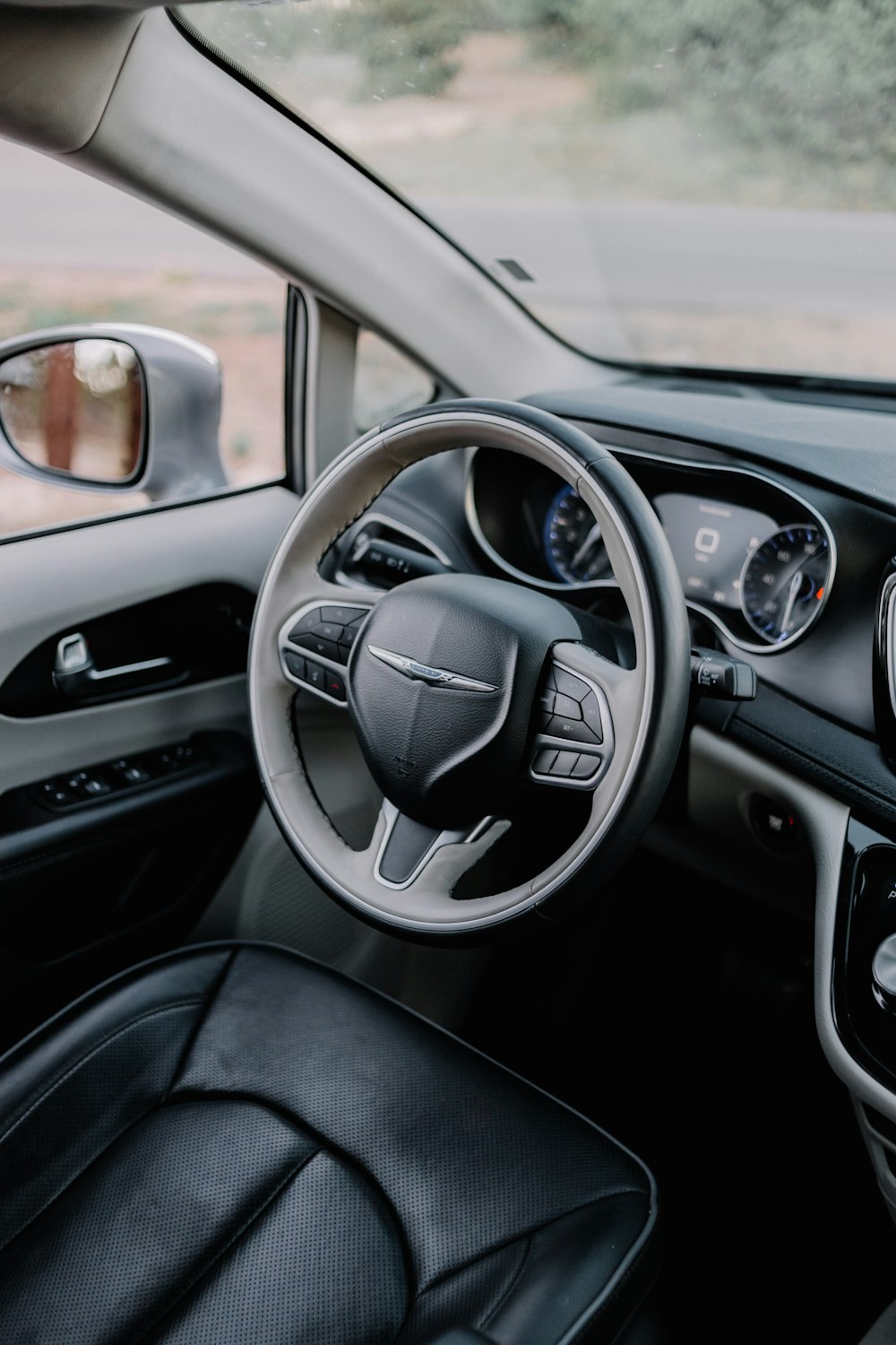 the interior of a car with a steering wheel and dashboard