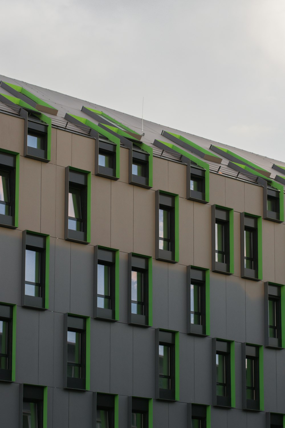 a tall building with lots of windows and green trim