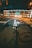 a person riding a bike down a street at night