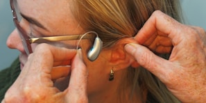 a woman is putting on a pair of glasses