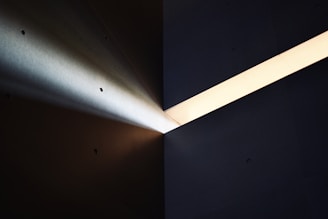 a light shines brightly on a dark wall