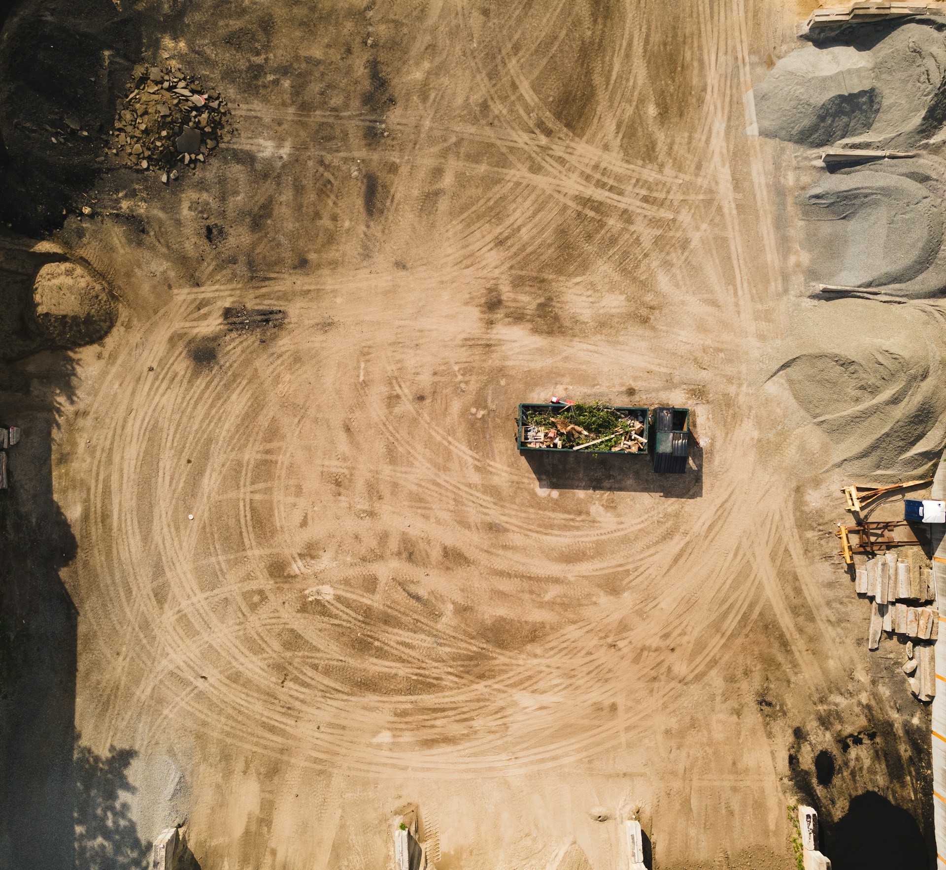 an aerial view of a dirt field with a truck