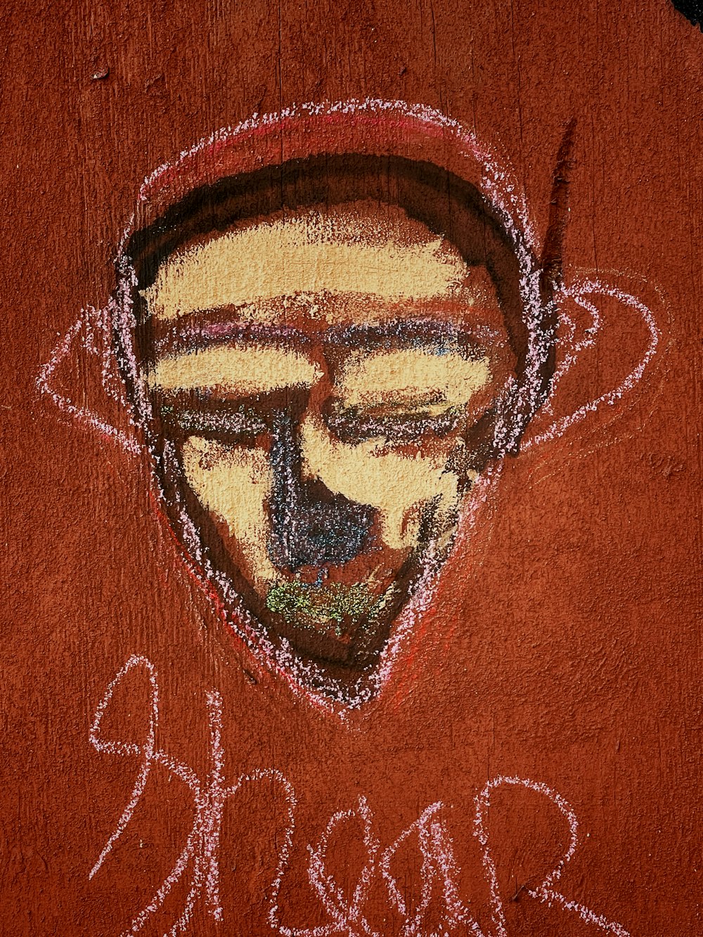 a drawing of a man's face on a red shirt