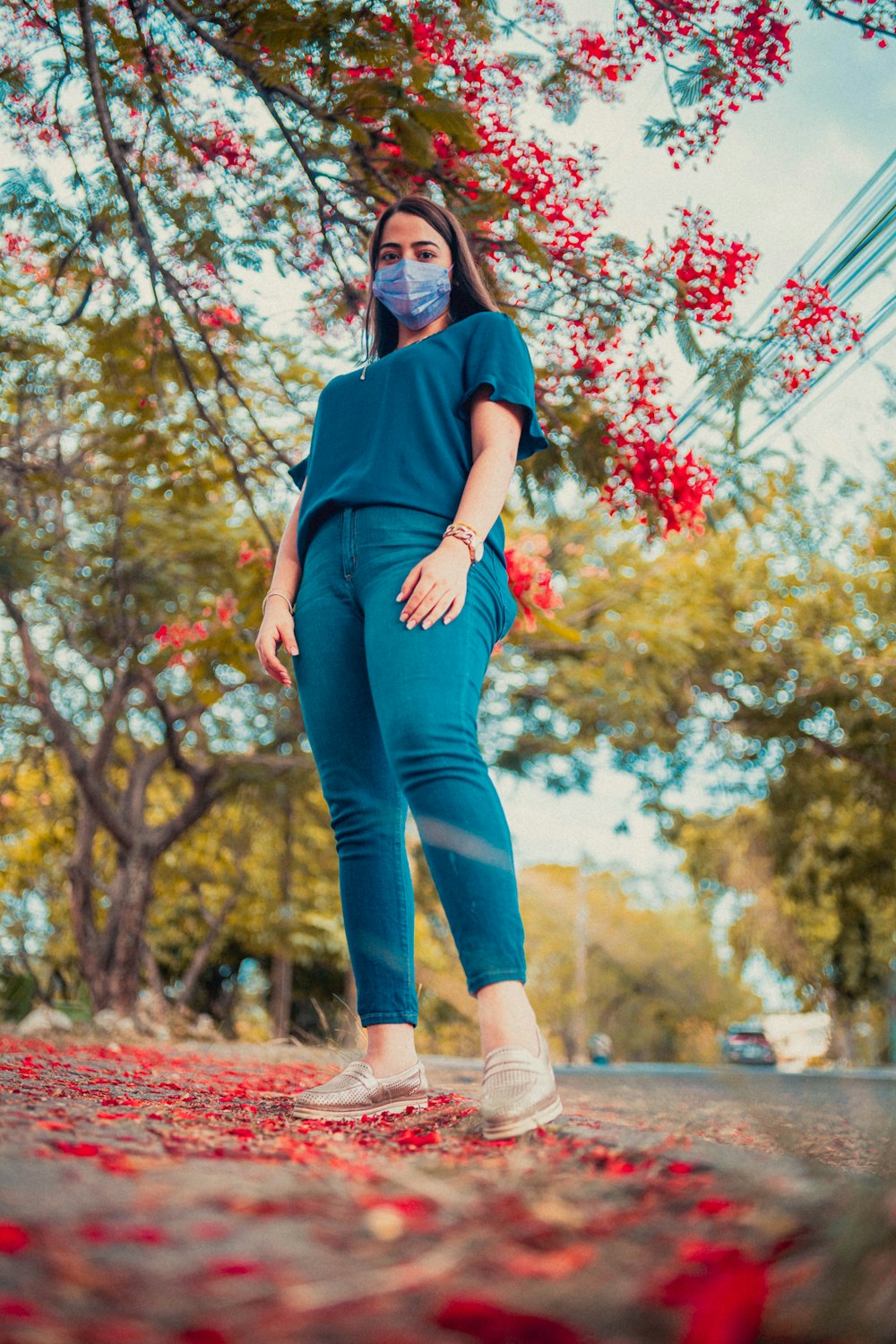 a woman wearing a face mask walking down a street