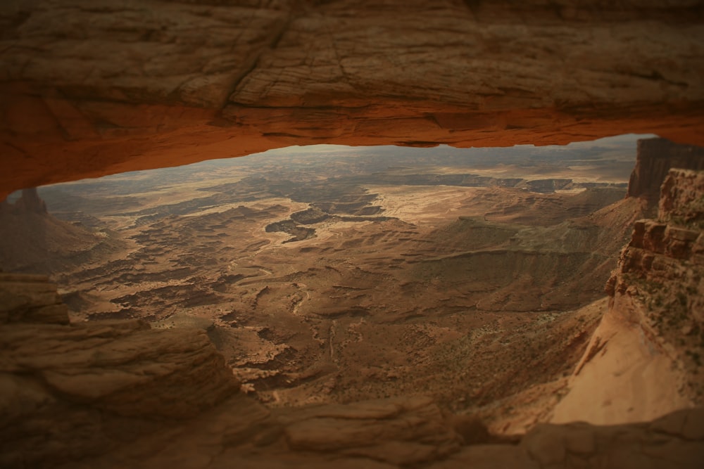 a view of the desert from inside a cave