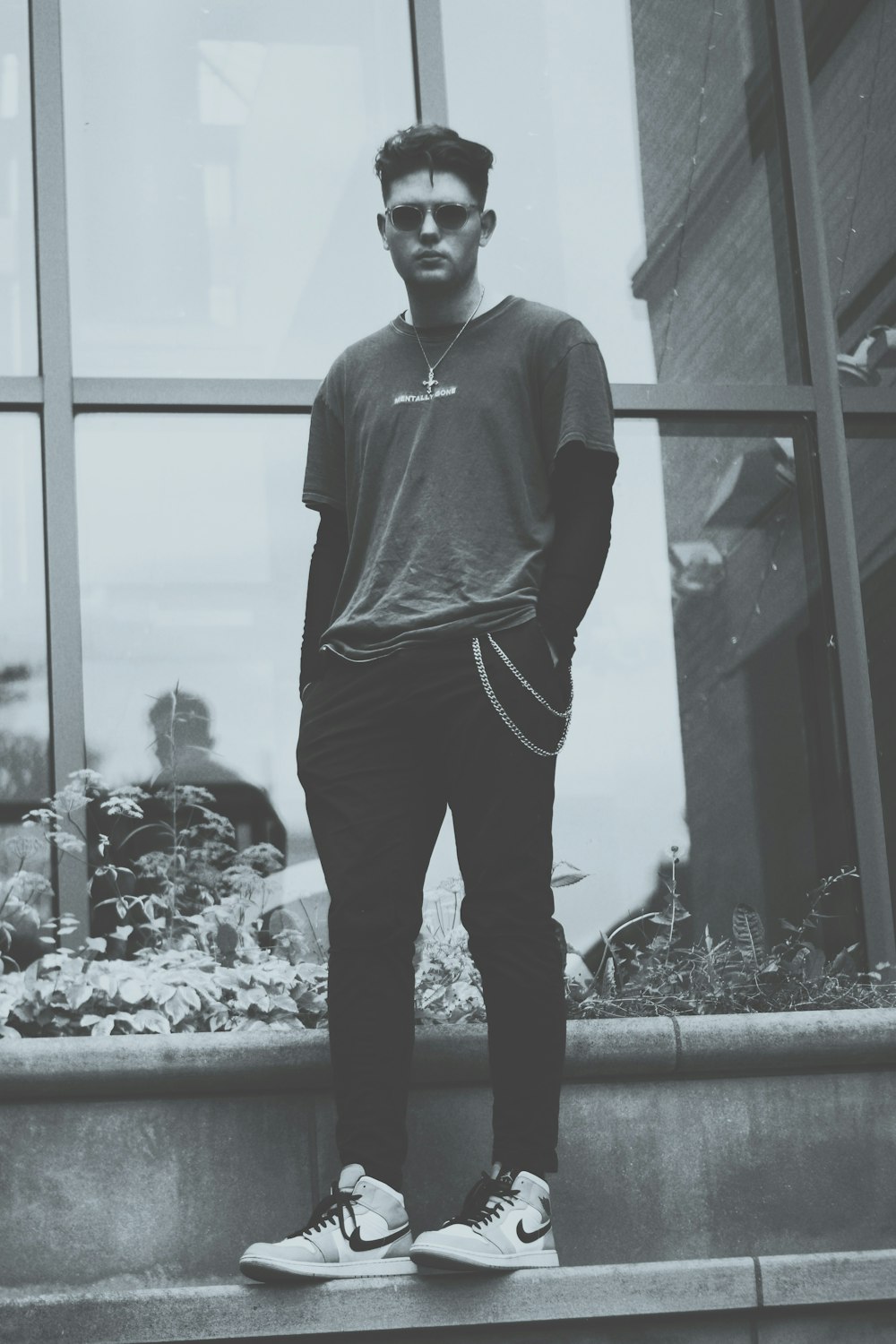 a man standing on a step in front of a window