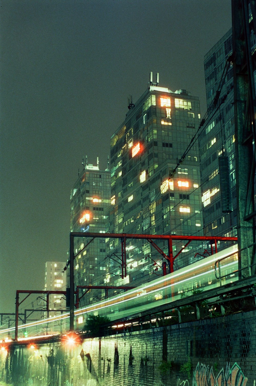 a train passing by a city at night