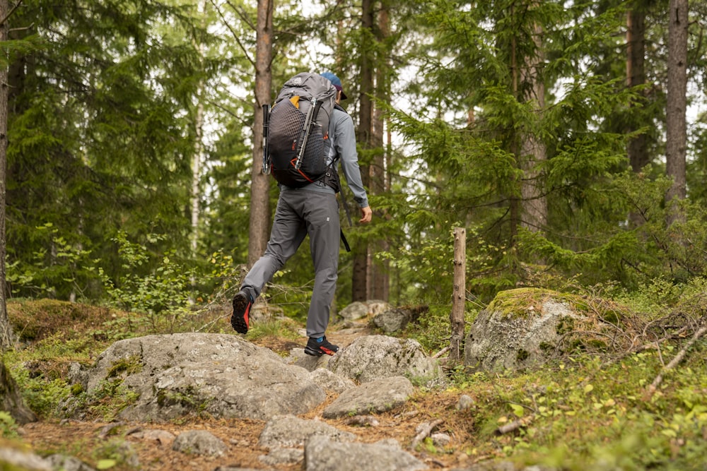 a man with a backpack is hiking through the woods