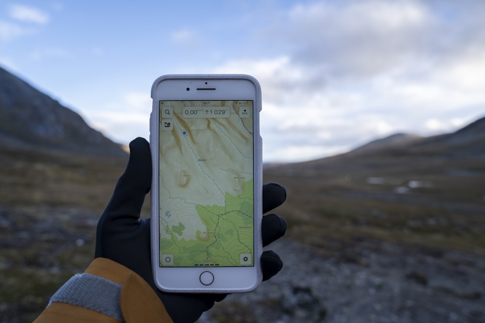 a person holding a cell phone with a map on it